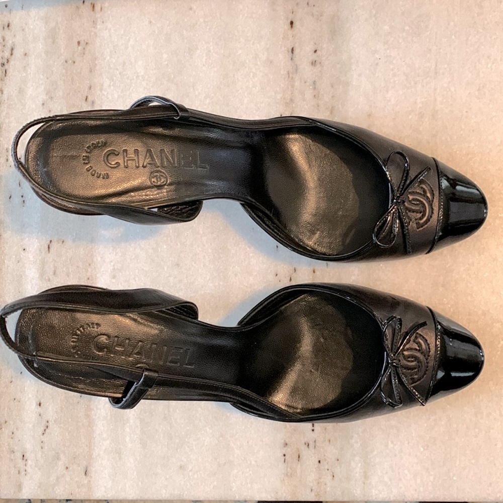 Brown and black tip toe Chanel slingback heels.
